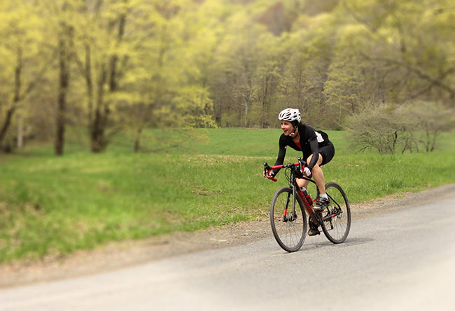 Young woman on bike clearly enjoying the gorgeous ride