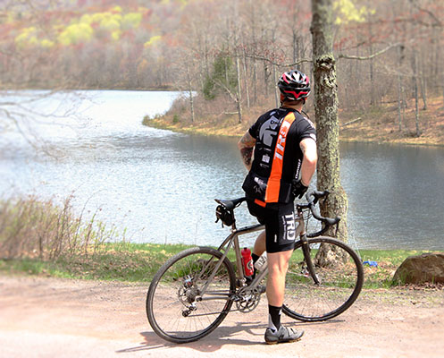 Cyclist pauses to take in the sights beside Cooper Lake